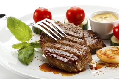 Grilled steak on a plate with tomatoes