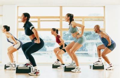 People taking an aerobic step class.