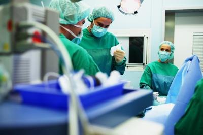 Doctor's performing surgery