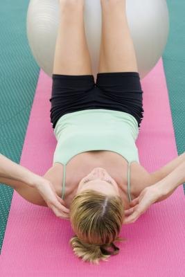 Woman doing sit ups with exercise ball
