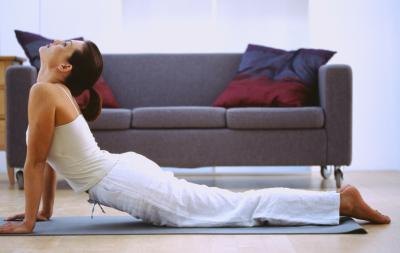 A woman does yoga in her living room.