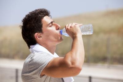Athletic man drinking water