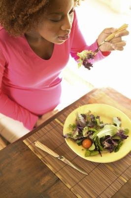 Pregnant woman eating a salad