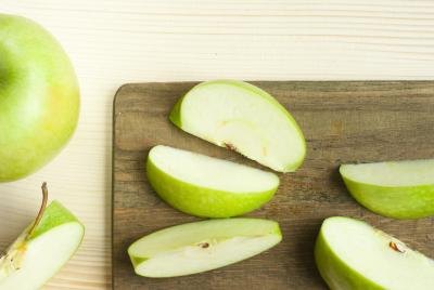 Sliced green apples on a cutting board