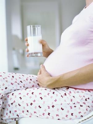 Pregnant woman with glass of milk