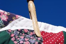 Drying a color-stained quilt in the dryer can bake in the stain.