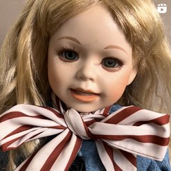 Closeup of scary doll with striped bow