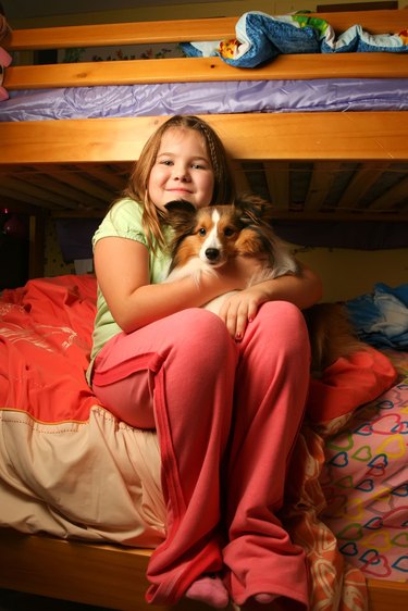 Young girl in her bedroom with pet