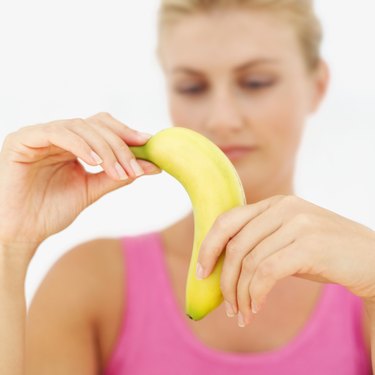 Close-up of a banana in a young woman's hands