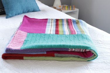 Snuggle up with a good book, a warm cup of tea, and your favorite jammies under this upcycled sweater quilt that you made yourself.