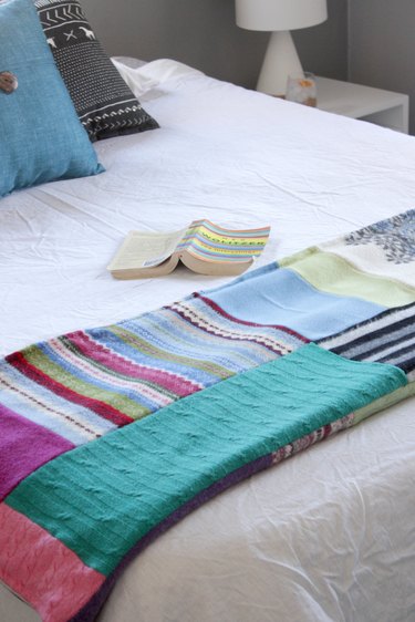 Snuggle up with a good book, a warm cup of tea, and your favorite jammies under this upcycled sweater quilt that you made yourself.