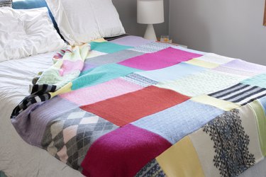 Snuggle up with a good book, a warm cup of tea, and your favorite jammies under this upcycled sweater quilt that you made yourself.