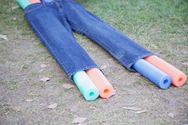 slip pool noodles through jeans legs