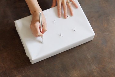 Cutting x-shaped holes in top of box