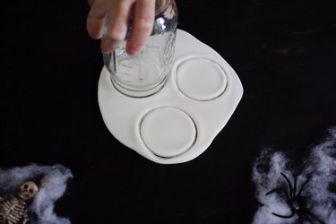 Cutting out white circles of fondant