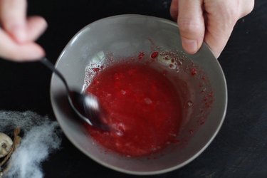Mixing red icing with water