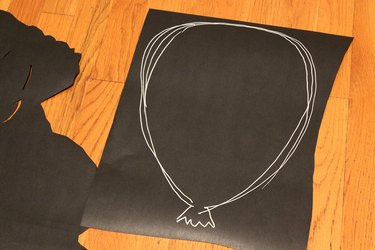 balloon shape traced onto black paper
