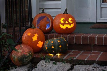 Five carved pumpkins on porch steps