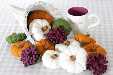 You can modernize your "horn of plenty" centerpiece this season by painting the basket white and creating some delightful felt gourds and flowers to fill it.