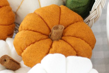 You can modernize your "horn of plenty" centerpiece this season by painting the basket white and creating some delightful felt gourds and flowers to fill it.