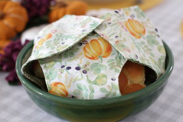 This holiday season, keep your rolls fresh and, at the same time, add some serious style to your table with a DIY fabric roll cover.