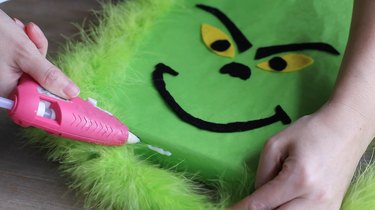 Gluing green feather boa in place