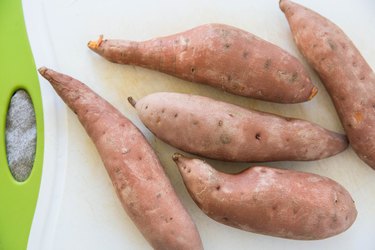 5 boiled sweet potatoes on a cutting board