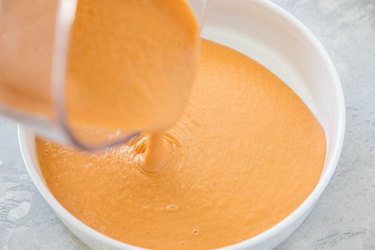 Souffle mixture being poured into a casserole dish