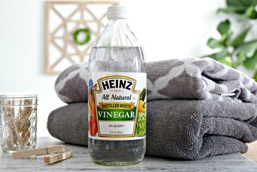 Bottle of vinegar with towels