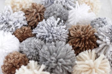 'Tis the season to make a cozy yuletide statement with this fuzzy pom pom wreath that you made yourself.