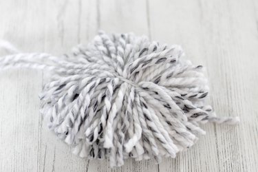 'Tis the season to make a cozy yuletide statement with this fuzzy pom pom wreath that you made yourself.