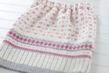 Pull out an old sweater from the bottom of your closet and create a cute and cozy sweater skirt for a little girl in your life.
