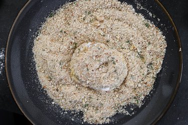 Coat tomatoes with bread crumbs