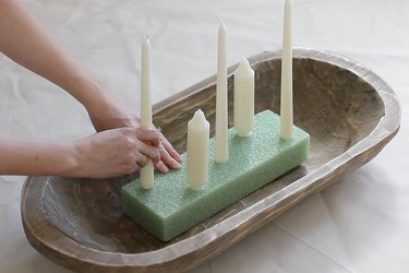 Twisting candles into floral foam