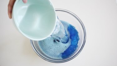 Pouring cold water into blue Jello mix