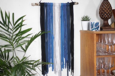 Grab some old t-shirts hanging around in your closet to create an eye-catching and stylish wall hanging.