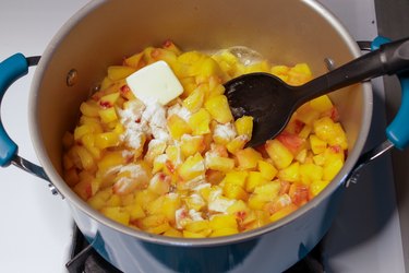 A pot of diced peaches with Sure Jell and butter