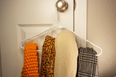An image of a scarf organizer made from plastic bottles.