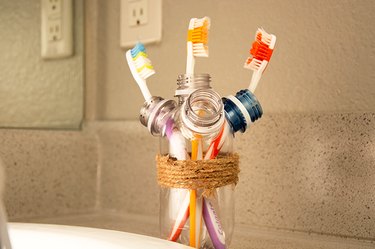 An image of a toothbrush holder made from old plastic bottles.