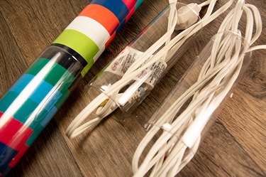 An image of cord and wrapping paper organizers made from plastic bottles.