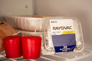 An image of candles and batteries in the freezer.
