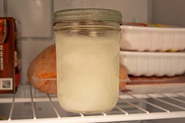 An image of a frozen mason jar in the freezer.