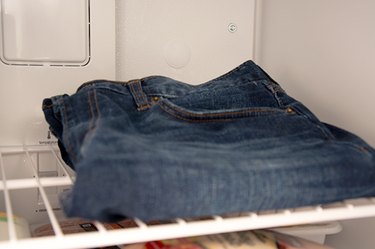 An image of denim jeans in the freezer.