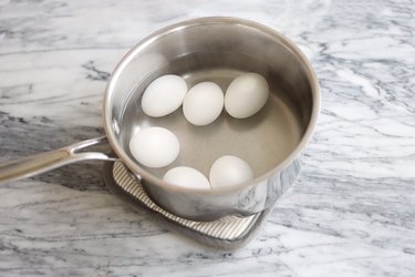 Six eggs in pan of water