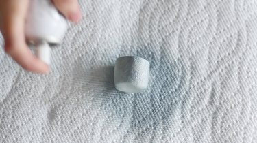 Spraying a marshmallow with edible silver paint
