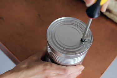 Adding holes to bottom of cans