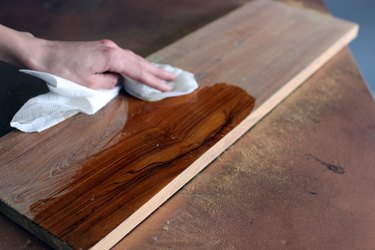 Wiping sandpaper dust from wood