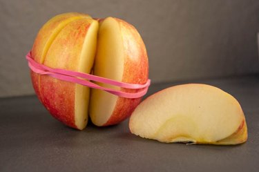 An image of an sliced apple rubber band hack