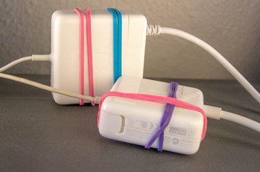An image of Mac Book power cords and rubber band hacks