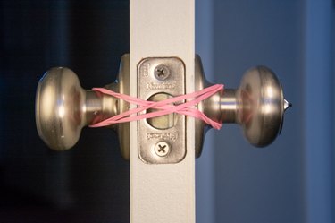 An image of a self-locking door rubber band hack